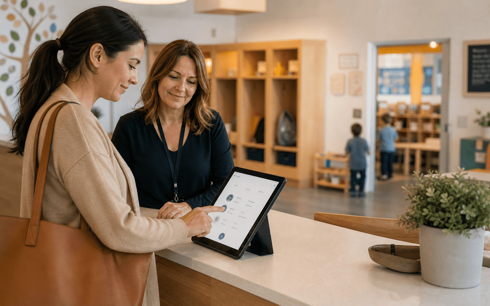A parent and school director using The BEE Suite at a childcare front desk